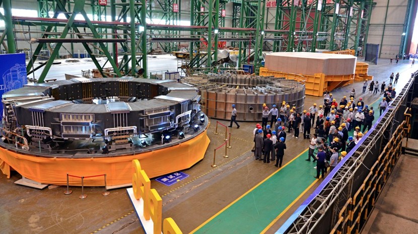 Ten metres in diameter, 1.2 metres in height, and with a cross-section of 1.6 metres: poloidal field coil #6 will be installed under the machine inside of the cryostat base. After six years of fabrication, the coil is ready to be shipped to ITER. (To the right of the completed component is the vacuum chamber where high-voltage tests were carried out and—further along—the transport case on the transport frame.) (Click to view larger version...)