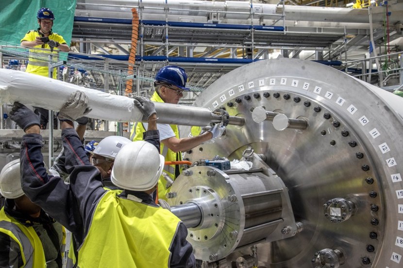 ITER Vacuum System Project Leader Robert Pearce (center) is seen here adjusting the ''cryojumper'' flange to the preproduction cryopump. Cold testing operations are not anticipated before May 2025, following the integrated commissioning of the ITER cryoplant. (Click to view larger version...)