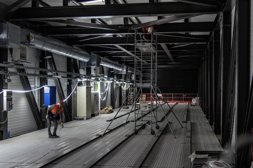 Originating in the twin Magnet Power Conversion Buildings, busbars will reach the Tokamak Building by way of two 50-metre-long ''bridges'' spanning the construction platform's main boulevard. The bridges are now in place and the installation of electrical equipment is ongoing. (Click to view larger version...)