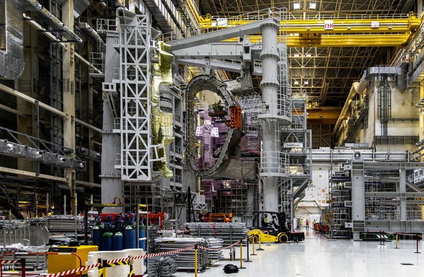 In the Assembly Hall, vacuum vessel #7 is now free of the dense scaffolding that kept it hidden for the better part of the year, its bevels restored to their nominal geometry. Attached to one of the tool's rotating wings, one of the sector's thermal shield panels, just back from repair in India, stands at a 90-degree angle. (Click to view larger version...)